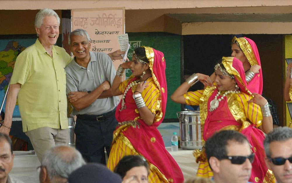 Former US President Bill Clinton is welcomed during a visit to `Akshaya Patra` kitchen in Jaipur.