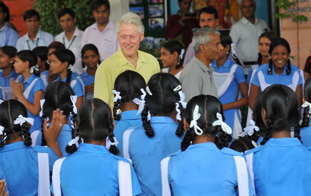 Former US President Bill Clinton with students during a visit to `Akshaya Patra` kitchen in Jaipur.