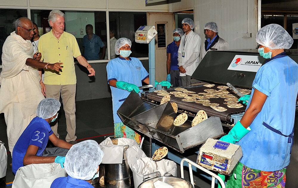 Former US President Bill Clinton during a visit to `Akshaya Patra` kitchen in Jaipur.