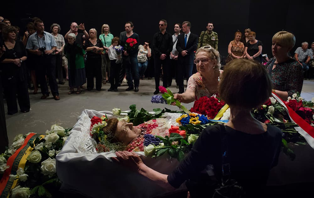 People pay their last respects while passing the coffin of Russian human rights activist Valeriya Novodvorskaya during a farewell ceremony inside the Sakhavov`s center in Moscow, Russia.