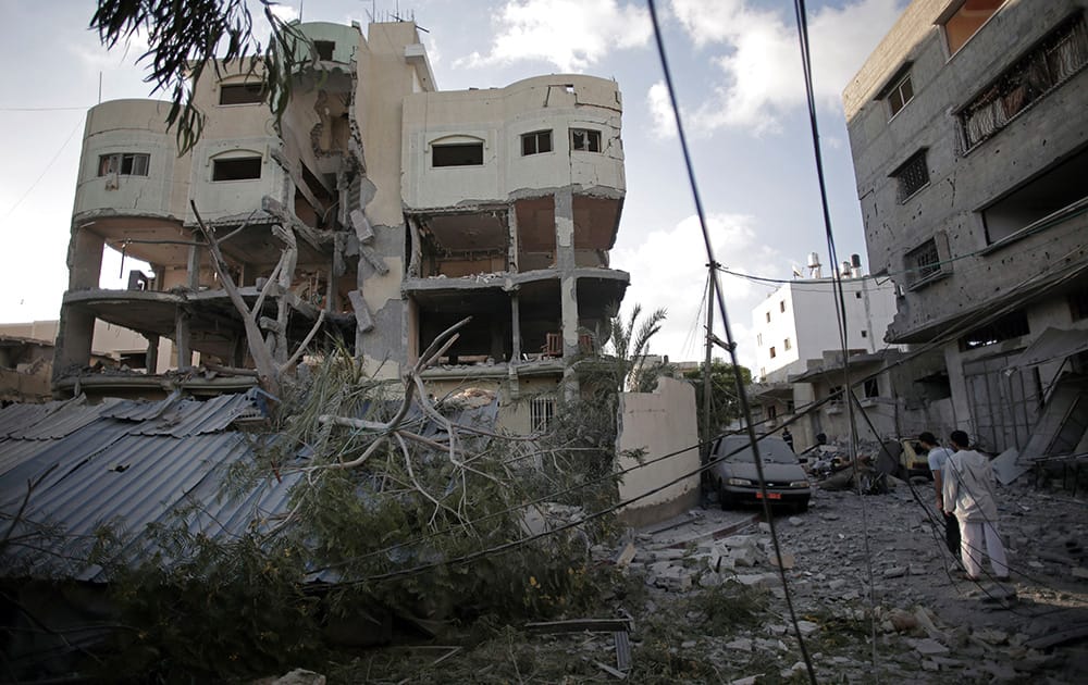 Palestinians inspect the damage to the house of Hamas leader, Mahmoud Zahar, following an early morning Israeli missile strike in Gaza City.