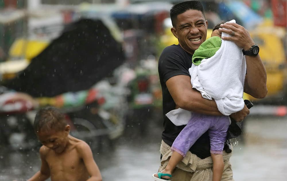 Residents at the slum community of Baseco evacuate to safer grounds at the onslaught of Typhoon Rammasun (locally known as Glenda) which battered Manila.