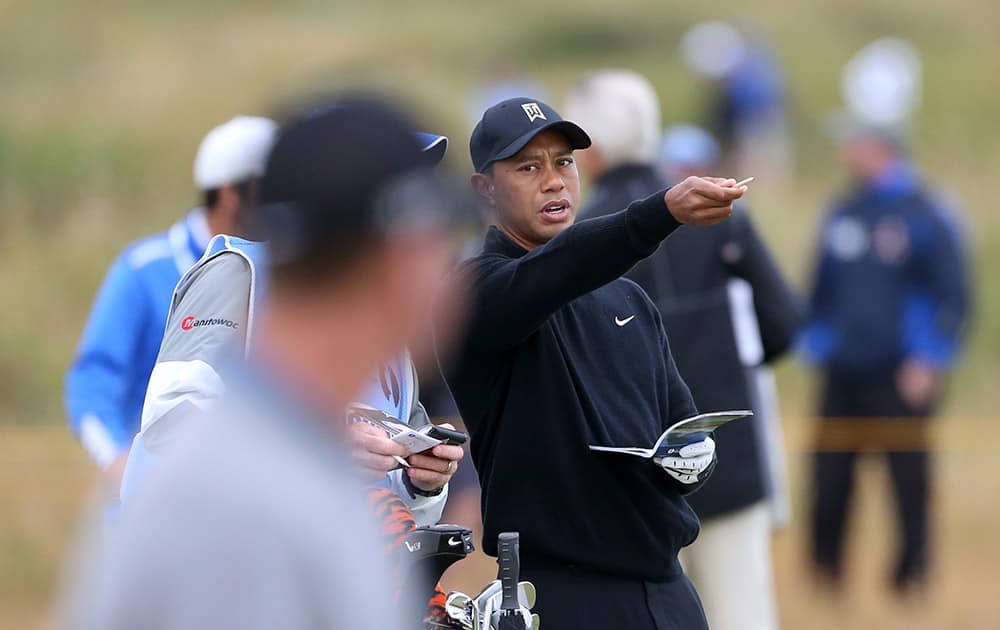 Tiger Woods of the US, right, talks with David Duval of the US on the 11th fairway during a practice round ahead of the British Open Golf championship at the Royal Liverpool golf club, Hoylake, England.