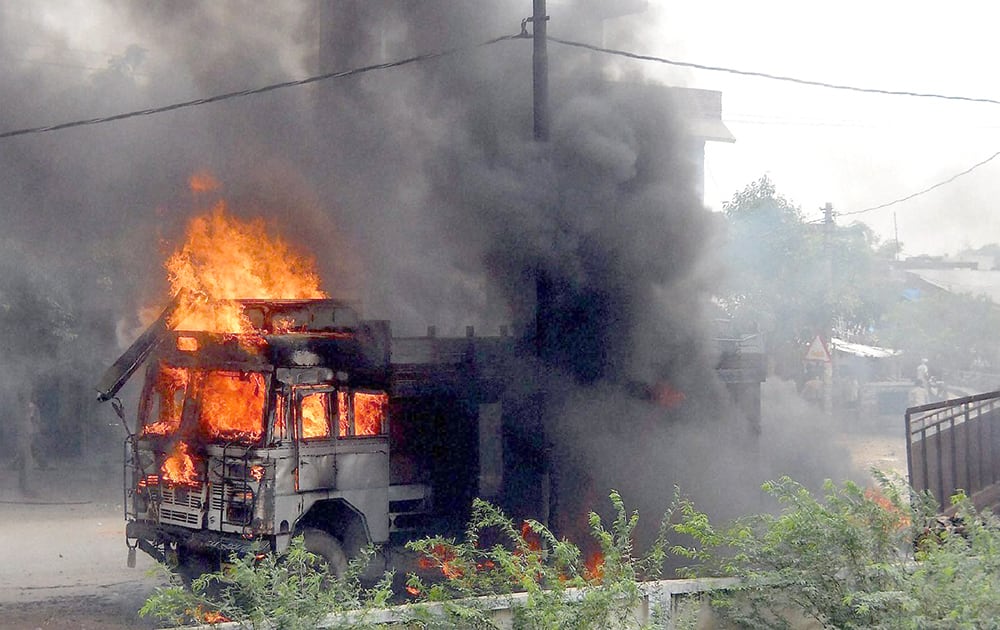 Locals set vehicles on fire in protest against gang-rape and suicide of a dalit woman in Hathras.