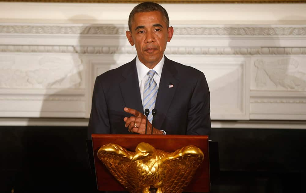 President Barack Obama speaks as he hosts an Iftar dinner, which celebrates the breaking of fast during the Muslim holy month of Ramadan in the State Dining Room at the White House in Washington.