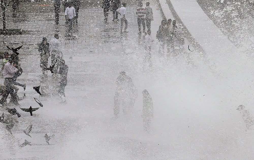 Indians enjoy high tide waves on the Arabian Sea coast in Mumbai.