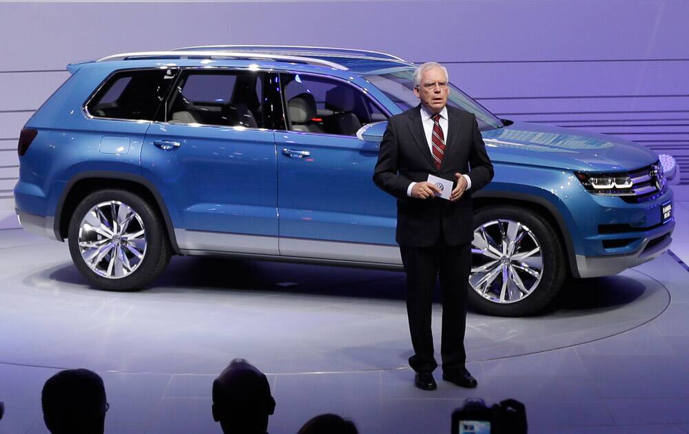 Ulrich Hackenberg, Volkswagen Director of Produce Development for Power Trains, stands next to the Volkswagen CrossBlue SUV concept vehicle during the North American International Auto Show in Detroit. It will build a new seven-passenger SUV based on the CrossBlue concept vehicle at its Chattanooga, Tenn. factory, adding about 2,000 jobs