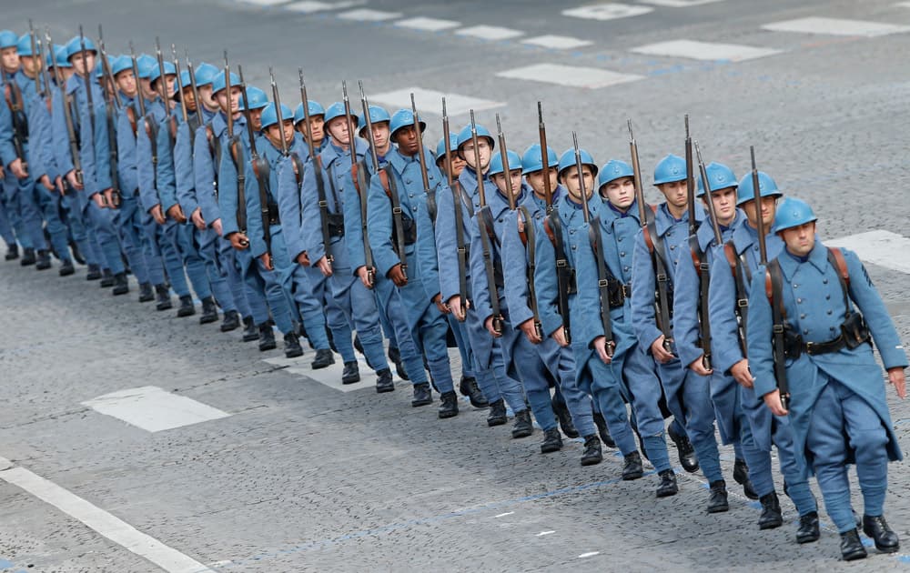 French soldiers dressed like WWI soldiers walk down the Champs-Elysees during the Bastille Day parade on in Paris, France.