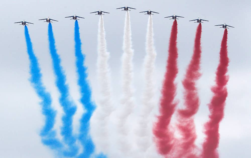 Jets for the Patrouille de France fly during the traditional Bastille Day parade OVER the Champs-Elysees avenue in Paris.