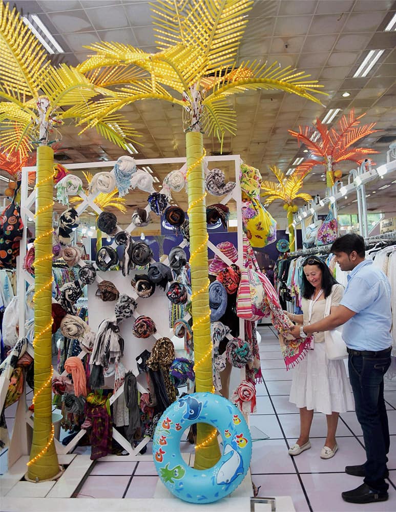 Visitors looking at items on display at a stall during the 53rd India International Garment Fair (IIGF) at Pragati Maidan in New Delhi.