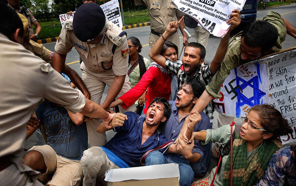 Indian policemen remove students protesting outside the Israeli embassy, in New Delhi.