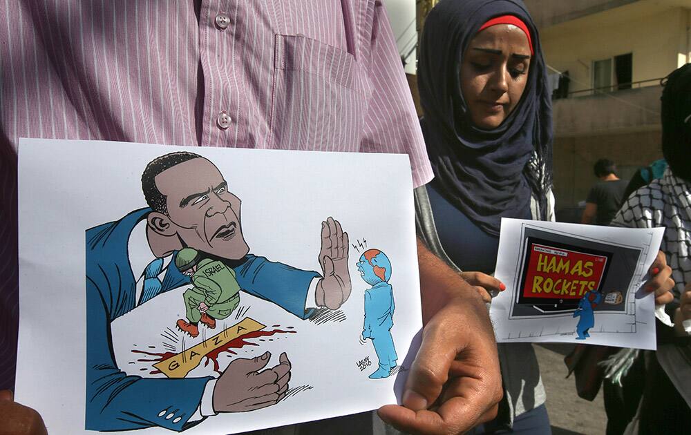 Lebanese activists hold placards as they protest against the Israeli offensive in Gaza, near the US Embassy in Aukar, east of Beirut, Lebanon.