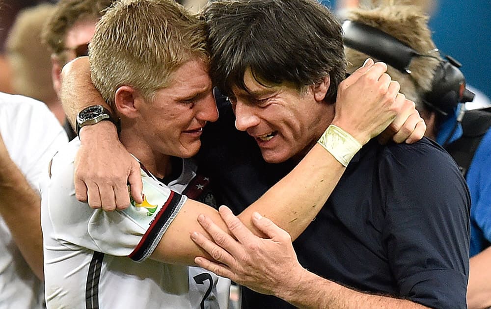 Germany`s Bastian Schweinsteiger and Germany`s head coach Joachim Loew embrace after the World Cup final soccer match between Germany and Argentina at the Maracana Stadium in Rio de Janeiro, Brazil.