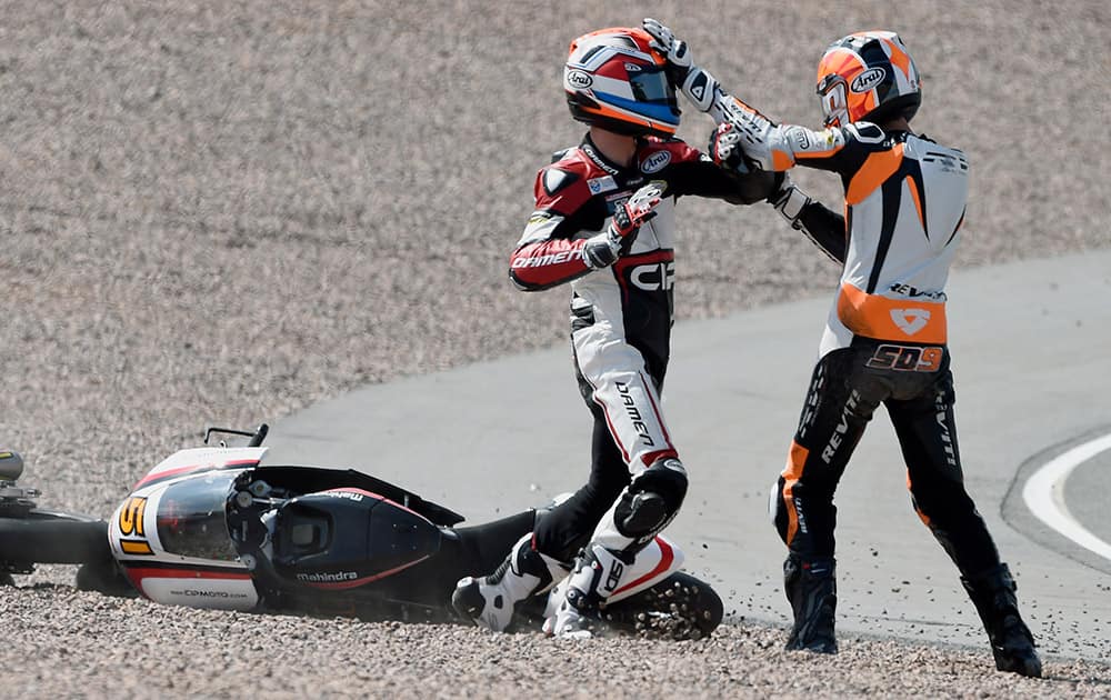 Bryan Schouten, left, and Scott Deroue, right, both from the Netherlands, fight after a crash during the Moto3 race at the Sachsenring circuit in Hohenstein-Ernstthal, Germany.