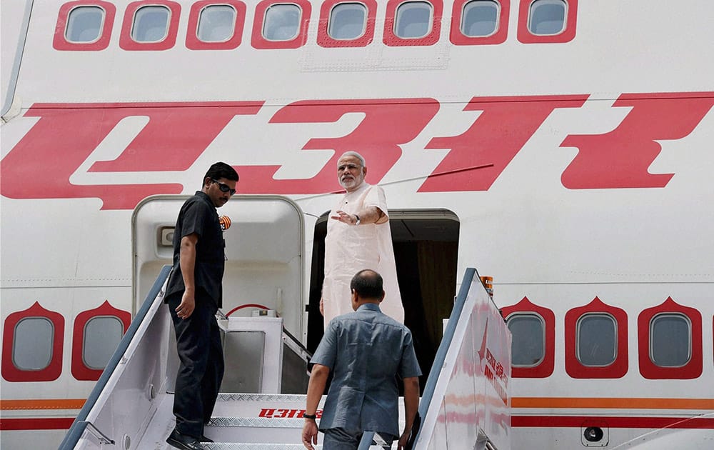 Prime Minister Narendra Modi waves as he leaves for Brazil to attend the five-nation BRICS summit, in New Delhi.