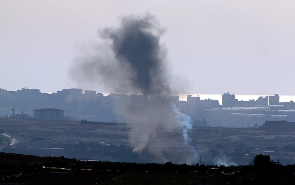 A smoke trail, right, of a failed rocket launch by Palestinian militants towards Israel, rises next to smoke after it crashed shortly after, as seen from the Israel-Gaza border.