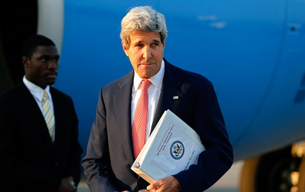 US Secretary of State John Kerry leaves his plane at Vienna International Airport as he arrives for talks with foreign ministers from the six powers negotiating with Tehran on its nuclear program in Vienna.