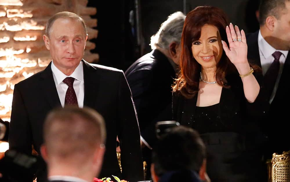 Russian President Vladimir Putin, left, as Argentina`s President Cristina Fernandez waves, during an official dinner at Government Palace in Buenos Aires, Argentina.