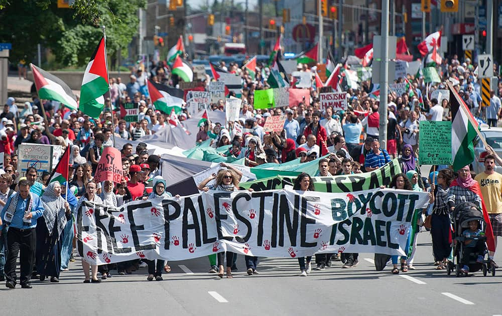 Protesters march along Elgin Street in Ottawa, Ontario, during a demonstration in response to the crisis in Gaza.