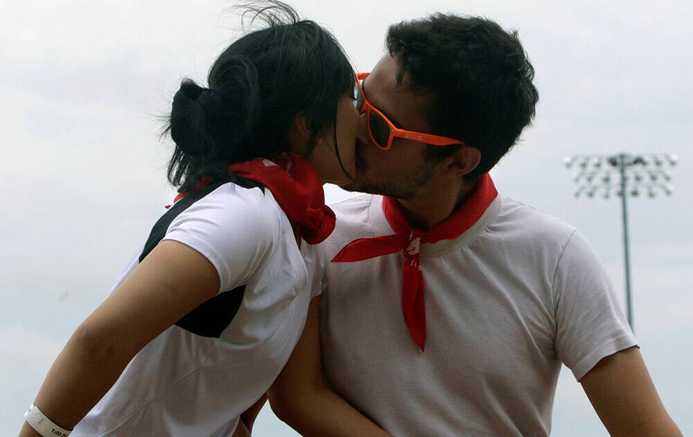 Participants kiss before The Great Bull Run, in Cicero, Ill. It was the first time the event was held in the Chicago area. 