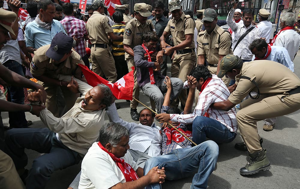 Indian policemen detain activists of left parties and other political parties during a protest against the ordinance on Polavaram project in Hyderabad.