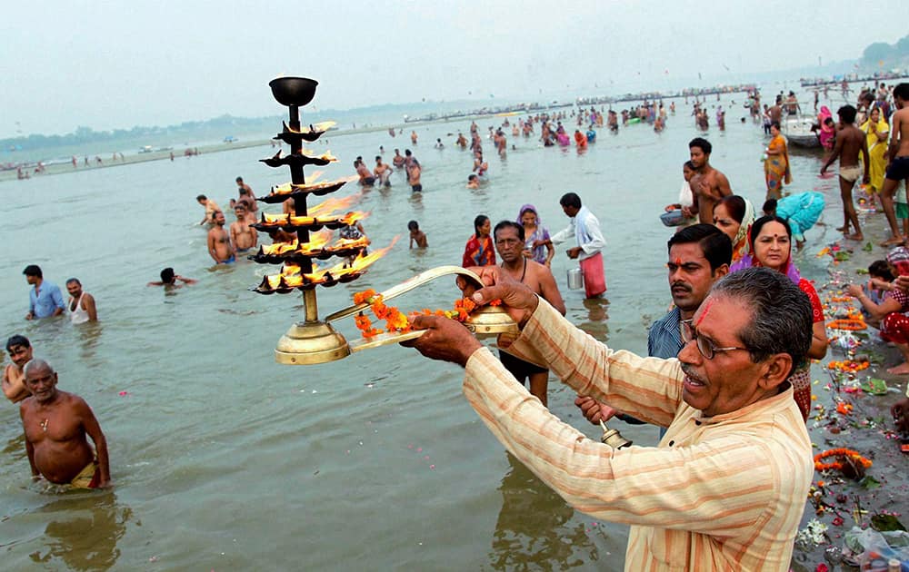 A devotee performs `aarti` after taking holy bath at the Sangam on the occasion of Guru Purnima festival in Allahabad.