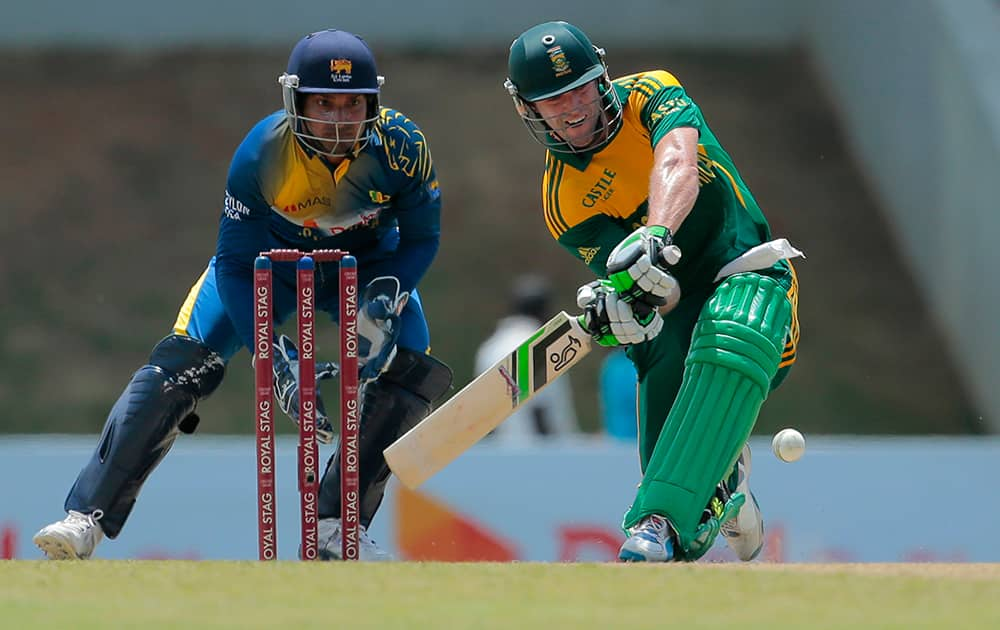 South African batsman AB de Villiers, right, plays a shot next to Sri Lankan wicketkeeper Kumar Sangakkara during their third one-day international cricket match in Sooriyawewa, Sri Lanka.