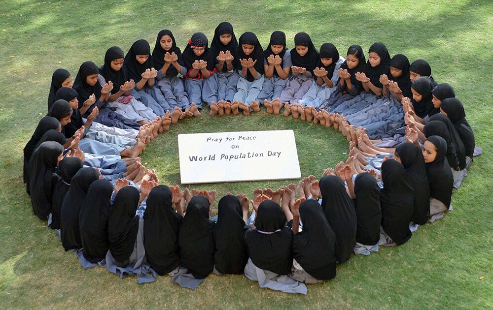 Muslim girls pray for peace in Jodhpur on `World Population Day`.