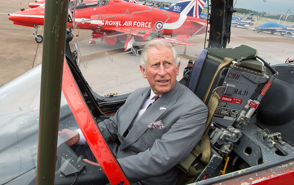 Britain`s Prince Charles sits in a cockpit as he visits The Royal International Air Tattoo to celebrate the Red Arrows` 50th display season, in RAF Fairford, England.