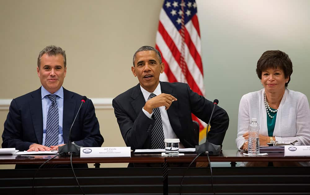 President Barack Obama, flanked by National Economic Council Director Jeff Zients, left, and senior White House Adviser Valerie Jarrett, meets with with company executives and their small business suppliers to talk about the economy.