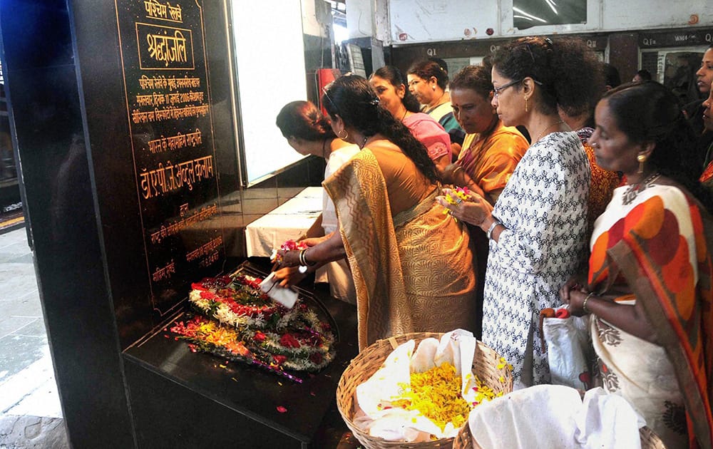 Women paying tribute to 7/11 serial train bomb blast victims at Mahim Railway Station in Mumbai.