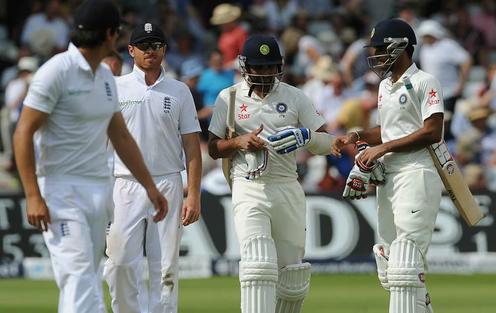 India`s Bhuvneshwar Kumar, right, Mohammed Shami, 2nd right, leave the pitch for tea interval alongside England`s Ian Bell, 2nd left, during day two of the first Test between England and India at Trent Bridge cricket ground, Nottingham.