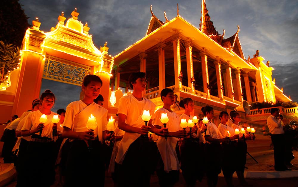 Cambodian dancers perform a candle light dance during the three-day Buddhist ceremony for late former King Norodom Sihanouk in front of the Royal Palace, in Phnom Penh, Cambodia.