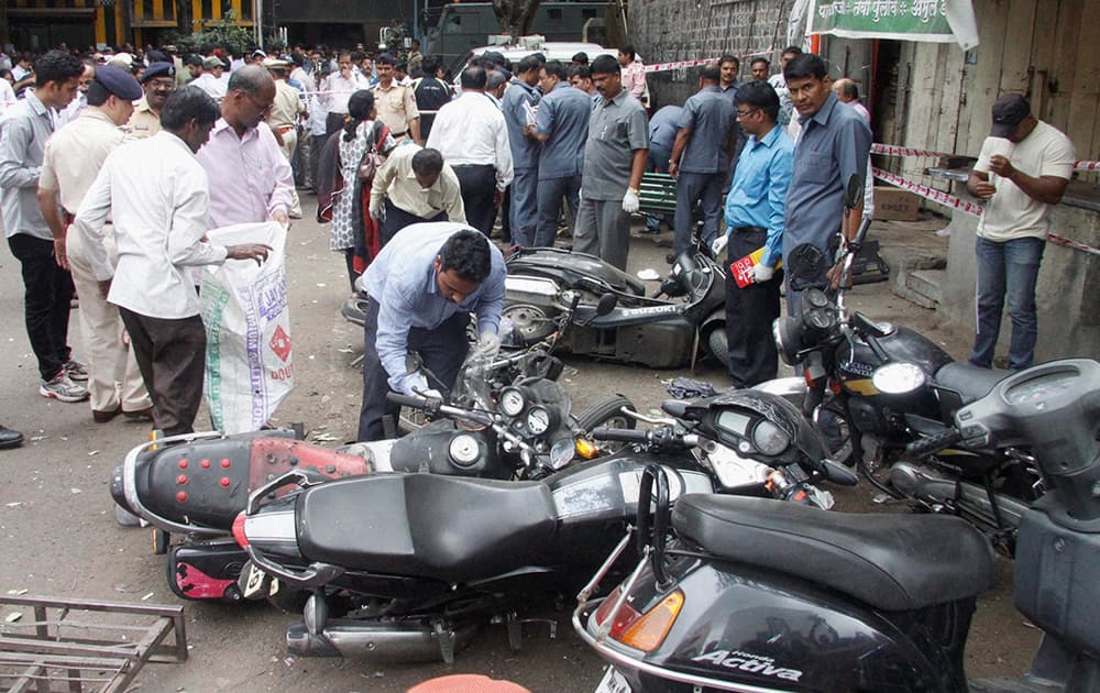 Police inspect the spot after a low intensity blast at a two-wheeler parked near a police station at a Budhwarpeth in Pune.