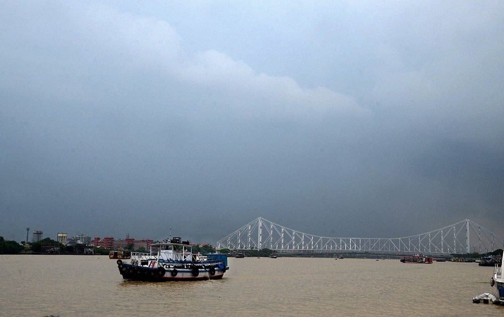 Dark clouds are seen in the sky over Howrah Bridge in Kolkata.