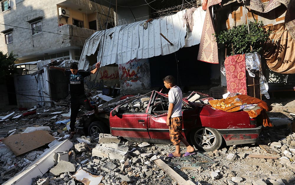 Palestinians inspect the rubble of a house after it was hit by an Israeli missile strike in Gaza City.