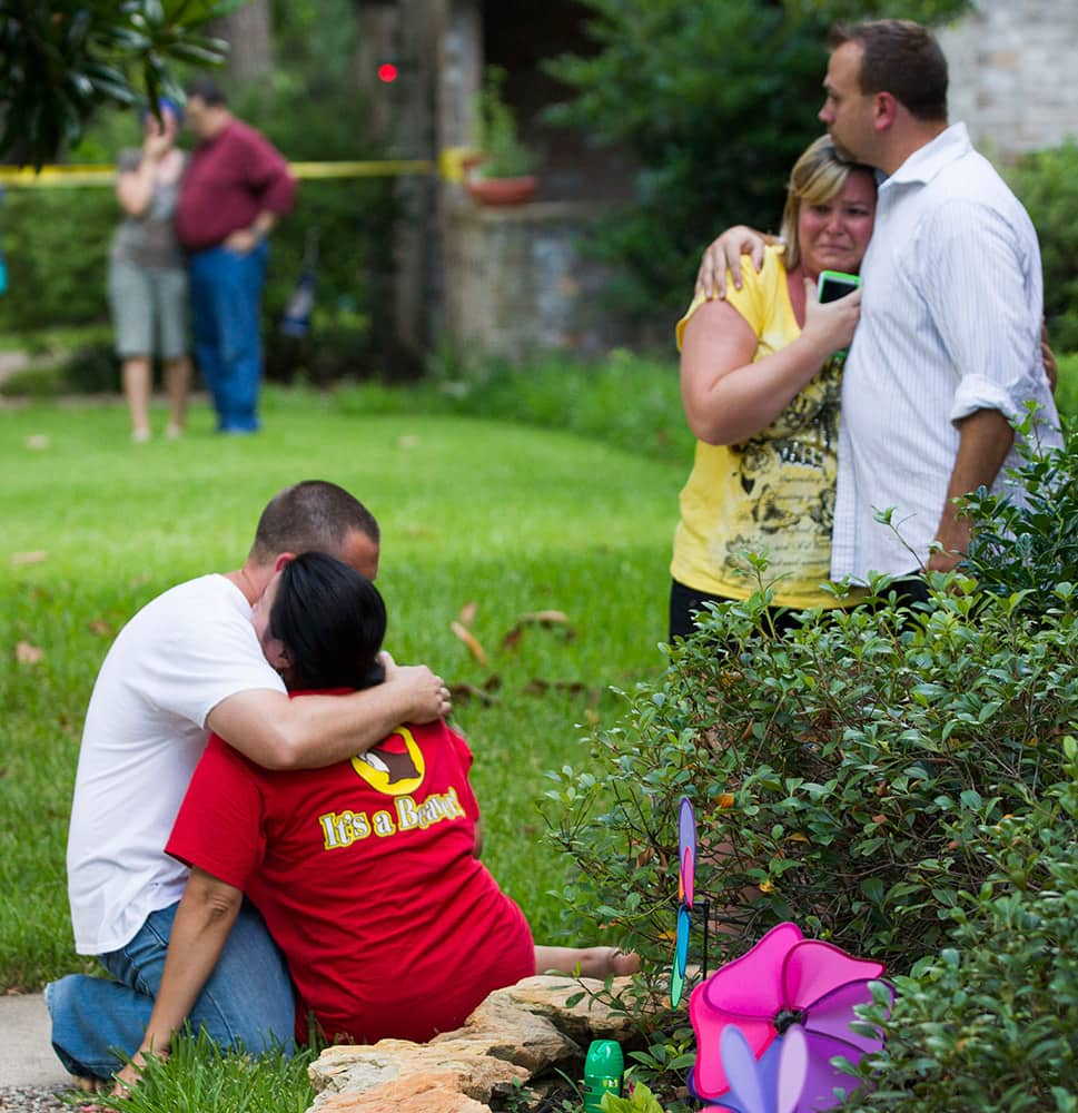 Neighbors embrace each other following a shooting in Spring, Texas. 