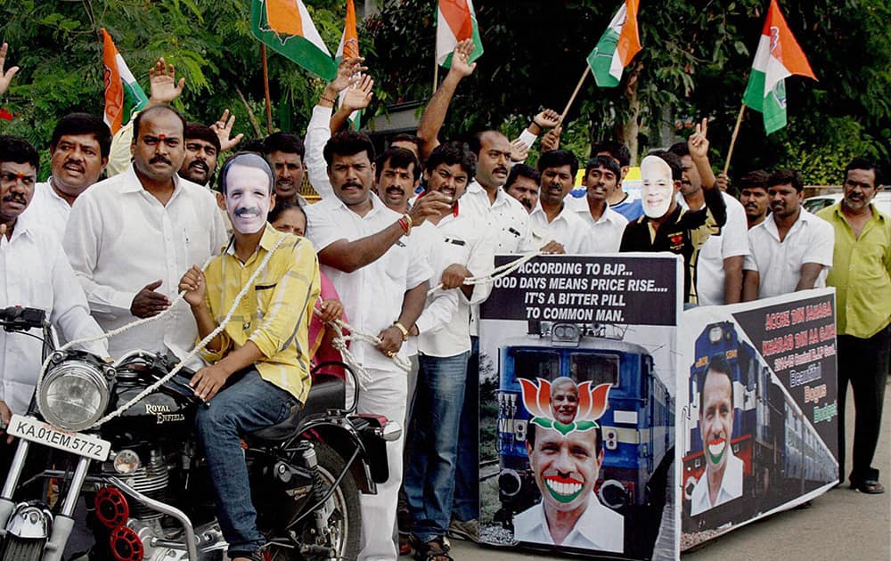 Congress party workers stage a protest against the Railway Budget in Bengaluru.