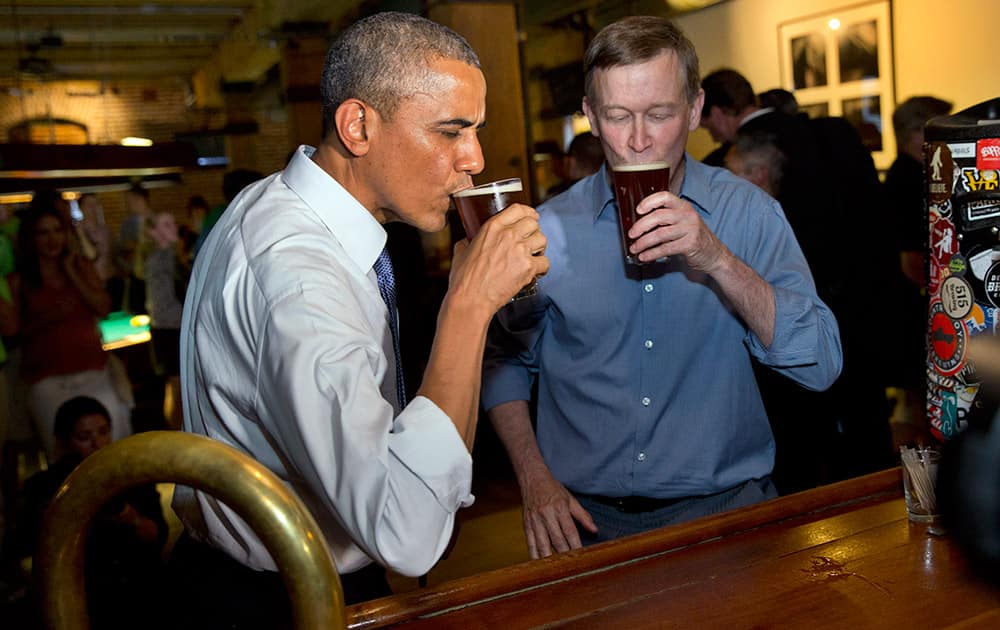 President Barack Obama has a beer at Wynkoop Brewing Co. with Colorado Gov. John Hickenlooper in Denver.