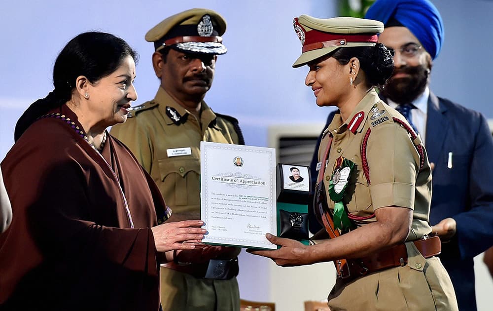 Tamil Nadu Chief Minister J Jayalalithaa honouring Divisional Fire Officer Priya Ravichandran of Tamil Nadu Fire and Rescue Services in a function in Chennai.