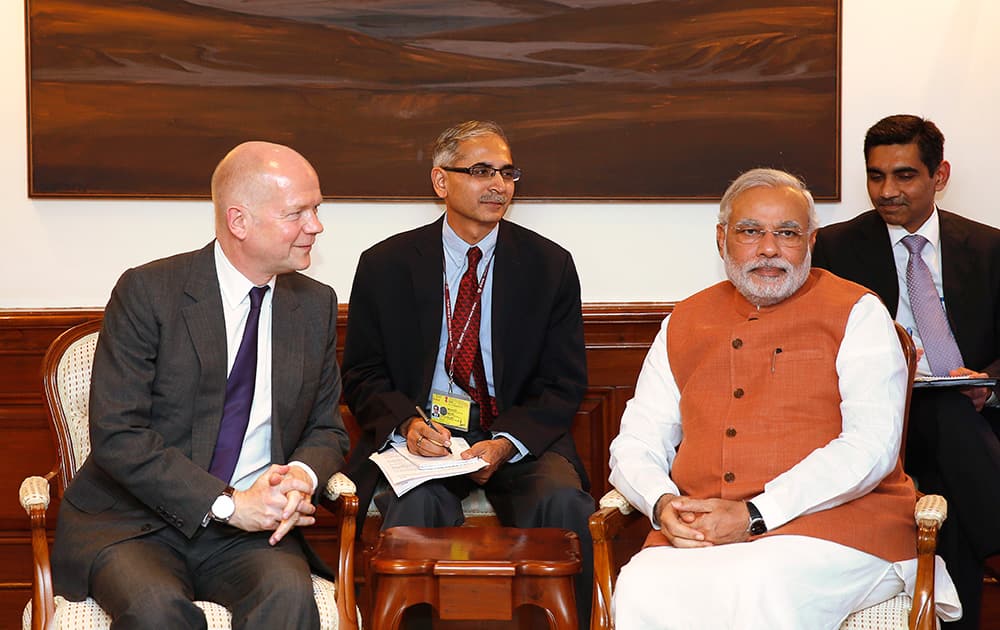 Indian Prime Minister Narendra Modi, right, sits with British Foreign Secretary William Hague during a meeting in New Delhi.