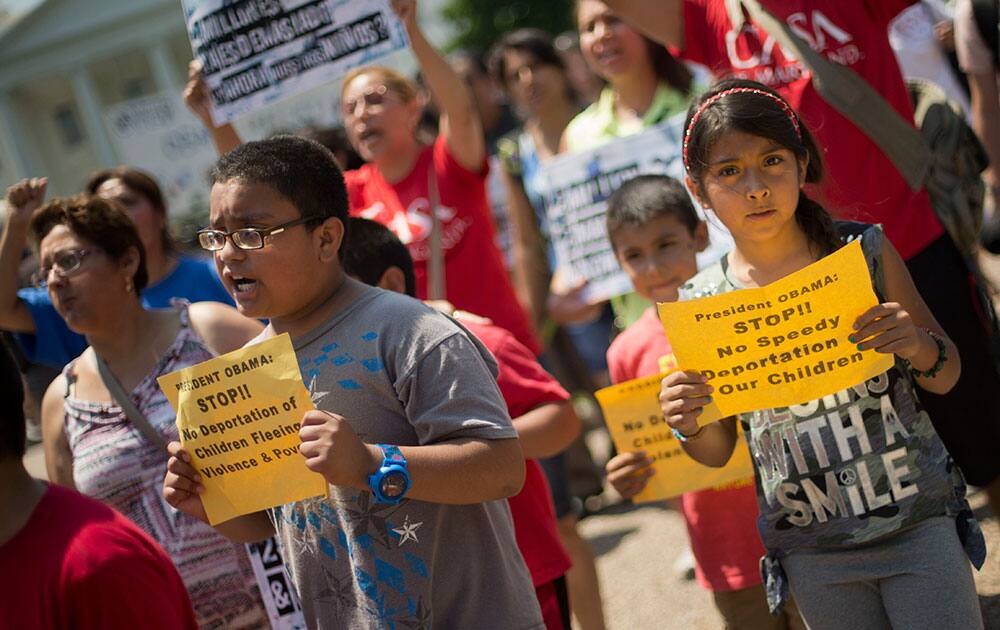 Alexandria Diaz, 9, from Baltimore, Md., joins her parents during a march in front of the White House in Washington, Monday, July 7, 2014, following a news conference of immigrant families and children`s advocates responding to the President Barack Obama`s response to the crisis of unaccompanied children and families illegally entering the US. 