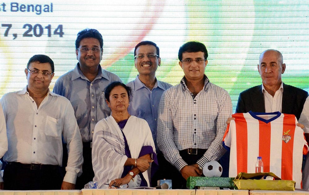 West Bengal Chief Minister Mamata Banerjee with former cricketer Sourav Ganguly, industrialist Sanjeev Goenka and other co-owners of Atletico de Kolkata during the unveiling of team`s jersey for the upcoming Indian Super League football tournament in Kolkata.