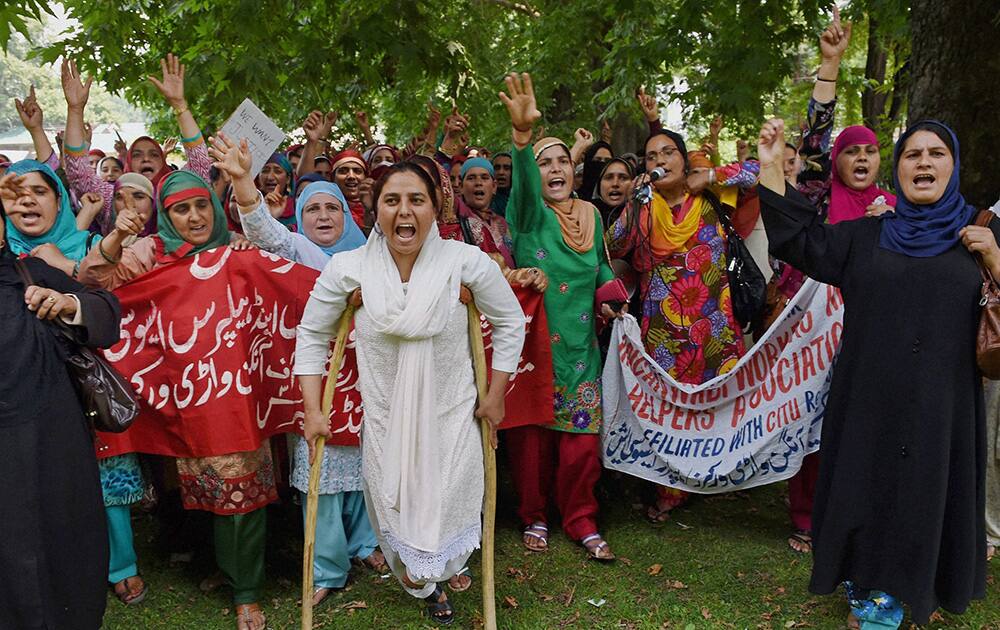 Members of Jammu and Kashmir Anganwadi Workers and Helpers Union (AWHU) shouting slogans during a protest march in support of their demands in Srinagar.