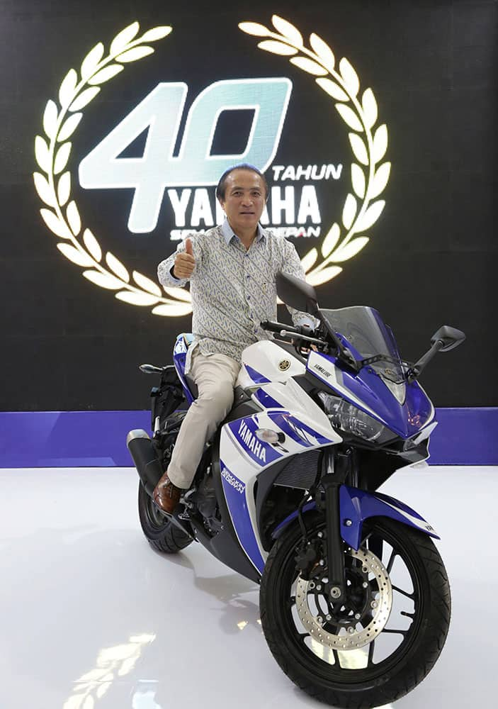 Chief Executive Officer and Representative Director Yamaha Motor Company Limited Hiroyuki Yanagi poses for photographer with a motor Yamaha R25 during celebration 40 years Yamaha in Jakarta, Indonesia.