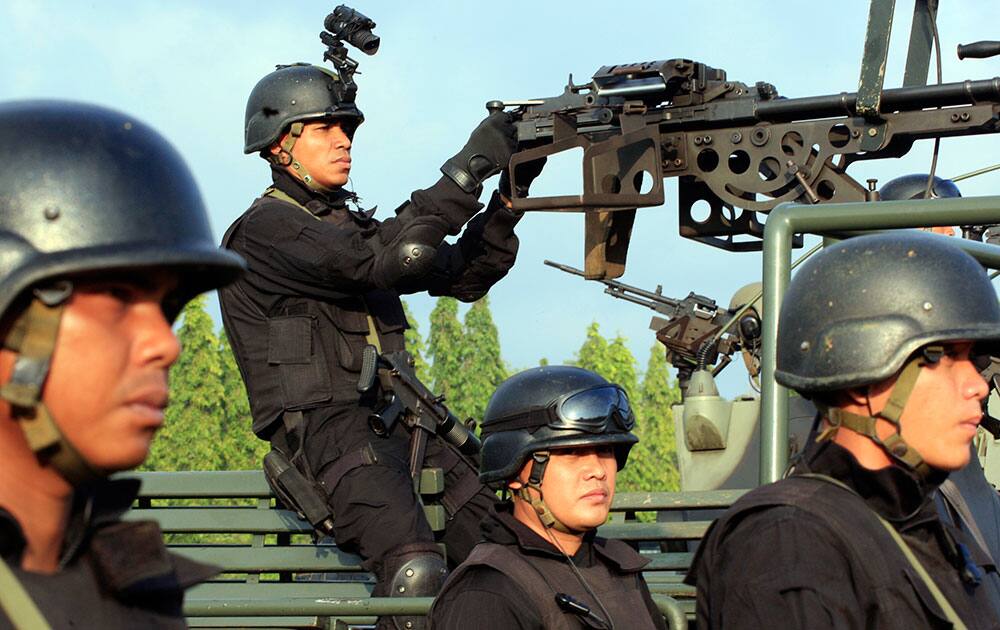 Indonesian soldiers take position during a security parade in preparation for the upcoming presidential election in Bali, Indonesia.