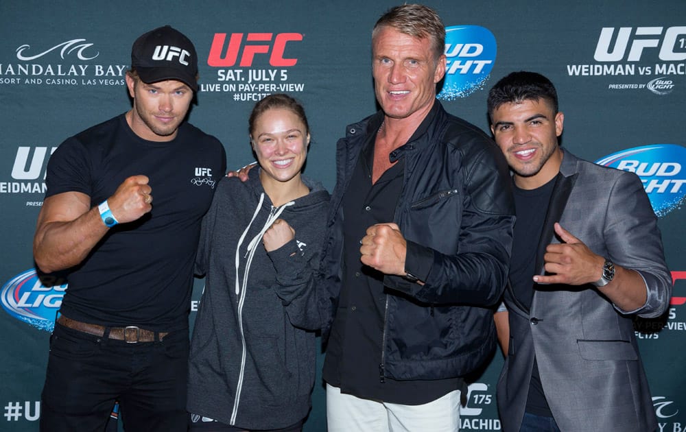 Kellan Lutz, left, Ronda Rousey, Dolph Lundgren and Victor Ortiz from this summer`s upcoming film The Expendables 3, pose for a photo just after UFC 175 at the Mandalay Bay Resort & Casino.