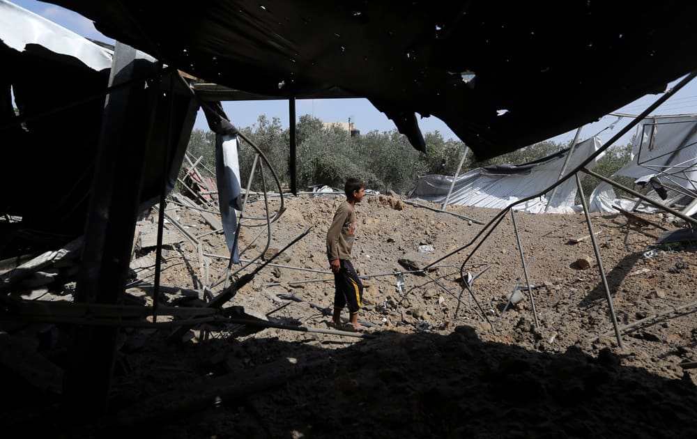 Palestinians inspect the rubble of a house after it was hit by an Israeli missile strike in Rafah, southern Gaza Strip.