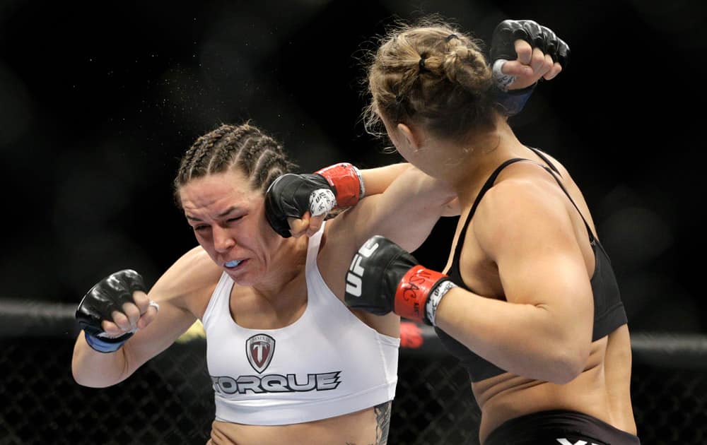 Ronda Rousey hits Alexis Davis during their women`s mixed martial arts bantamweight title bout at UFC 175 in Las Vegas.