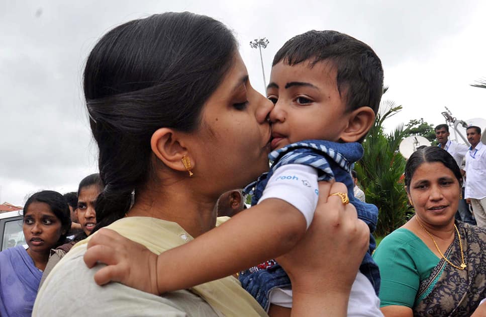 An Indian nurse, who was among 46 nurses stranded in territory held by Islamic extremists in Iraq, kisses her nephew upon arrival at the airport in Kochi.